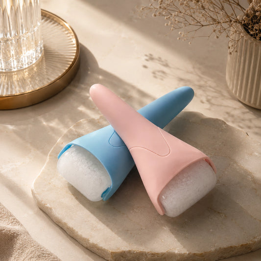 Two lint roller attachments in pastel pink and light blue, shown with white lint rolls on a stone tray in a styled indoor setting.